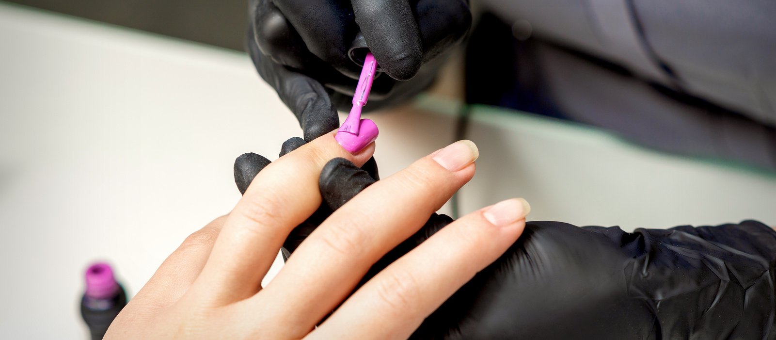 Manicure Master Applying Pink Nail Polish