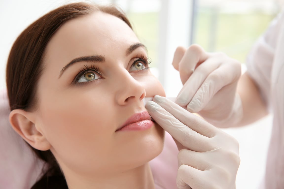 Woman Having Hair Removal Procedure on Face with Wax Depilatory in Salon