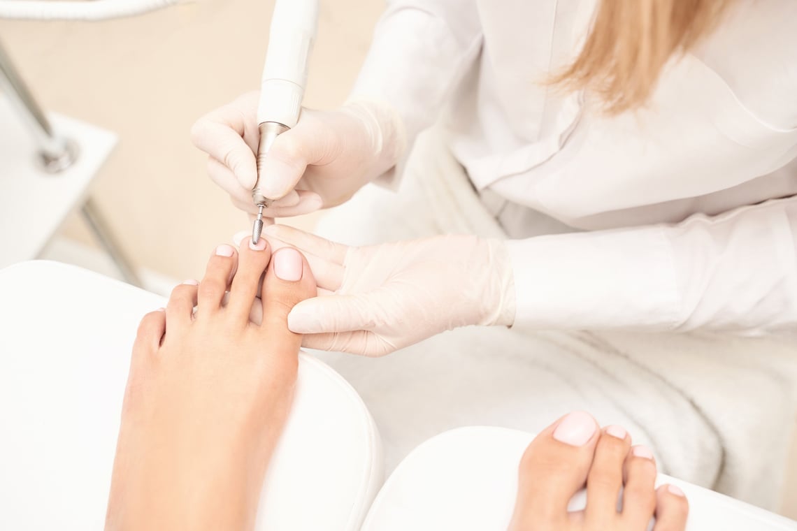 Classic Pink Wedding Toe Nail Manicure on White Backdrop. Spa Treatment Concept